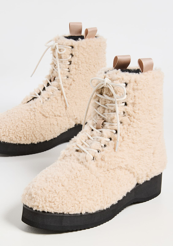 A pair of combat boots lined with off-white bouclé fabric