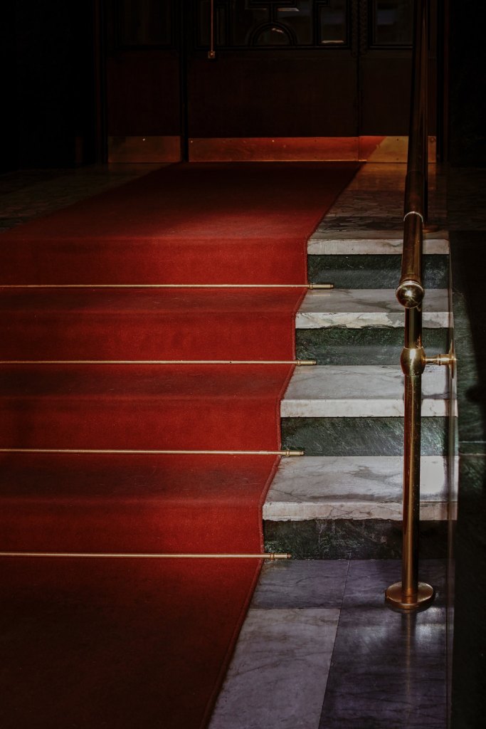 Marble stairs lined with a red carpet
