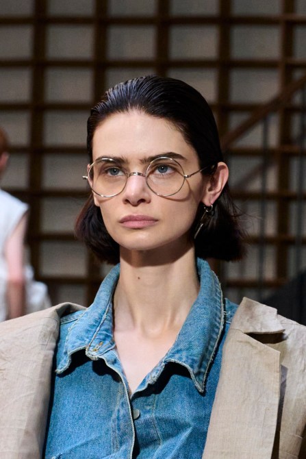 Runway model wearing thin wire frames.