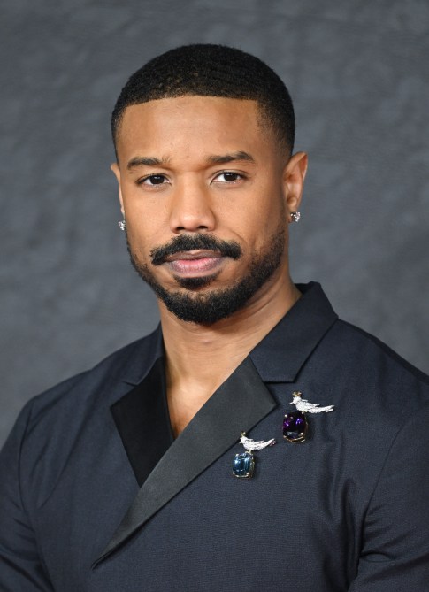 Michael B. Jordan wearing two jewel brooches