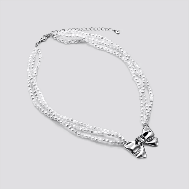 A Target beaded choker necklace with a metal bow accent