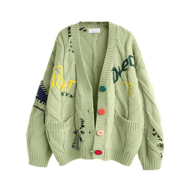 A light green cable-knit cardigan with decorative embroidery