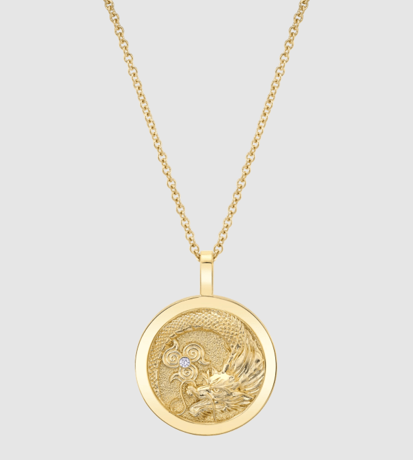 A gold Anita Ko necklace with a dragon pendant