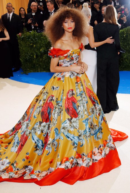 Zendaya in a yellow, red, and blue parrot-printed gown at the 2017 Met Gala