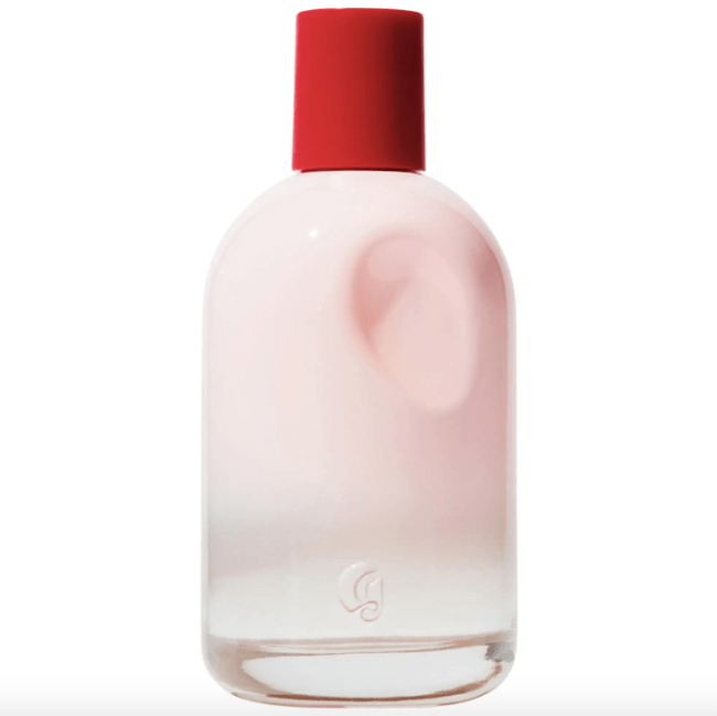 Glossier You in a baby pink bottle with a red cap.