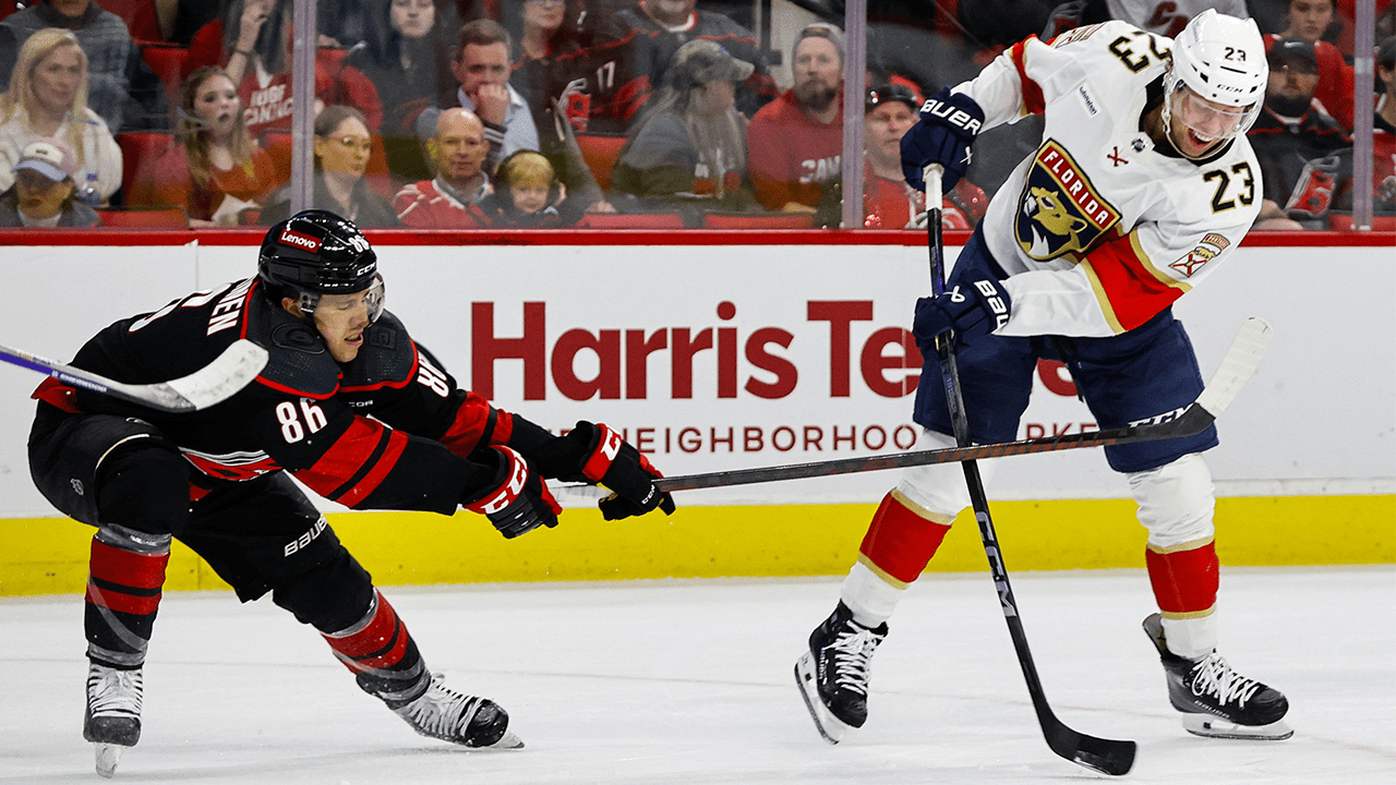 Carter Verhaeghe #23 of the Florida Panthers shoots the puck with Teuvo Teravainen #86 of the Carolina Hurricanes attempting to block him during the first period of the game at PNC Arena on March 14, 2024 in Raleigh, North Carolina. Hurricanes defeat Panthers 4-0.