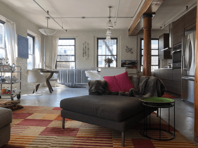 Artist loft Airbnb in New York City. Views of living room and kitchen in apartment.