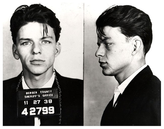 Pop singer Frank Sinatra poses for a mug shot after being arrested and charged with "carrying on with a married woman" in 1938 in Bergen County, New Jersey.