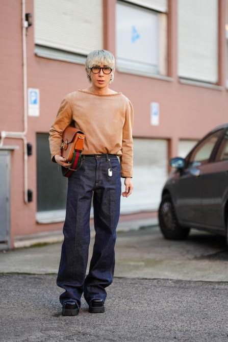 A fashion week guest wearing black aviator glasses.