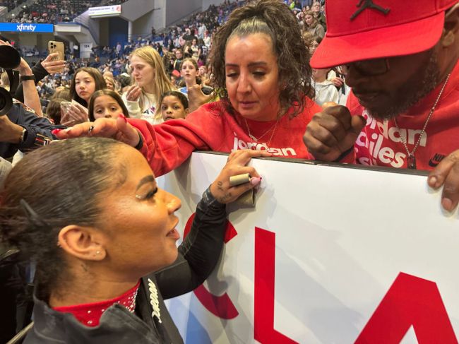 Jordan Chiles is congratulated by her parents Timothy and Gina Chiles after her performance  during the 2024 Core Hydration Gymnastics Classic at the XL Centre, Hartford on May 18th, 2024, in Hartford, Connecticut. USA.