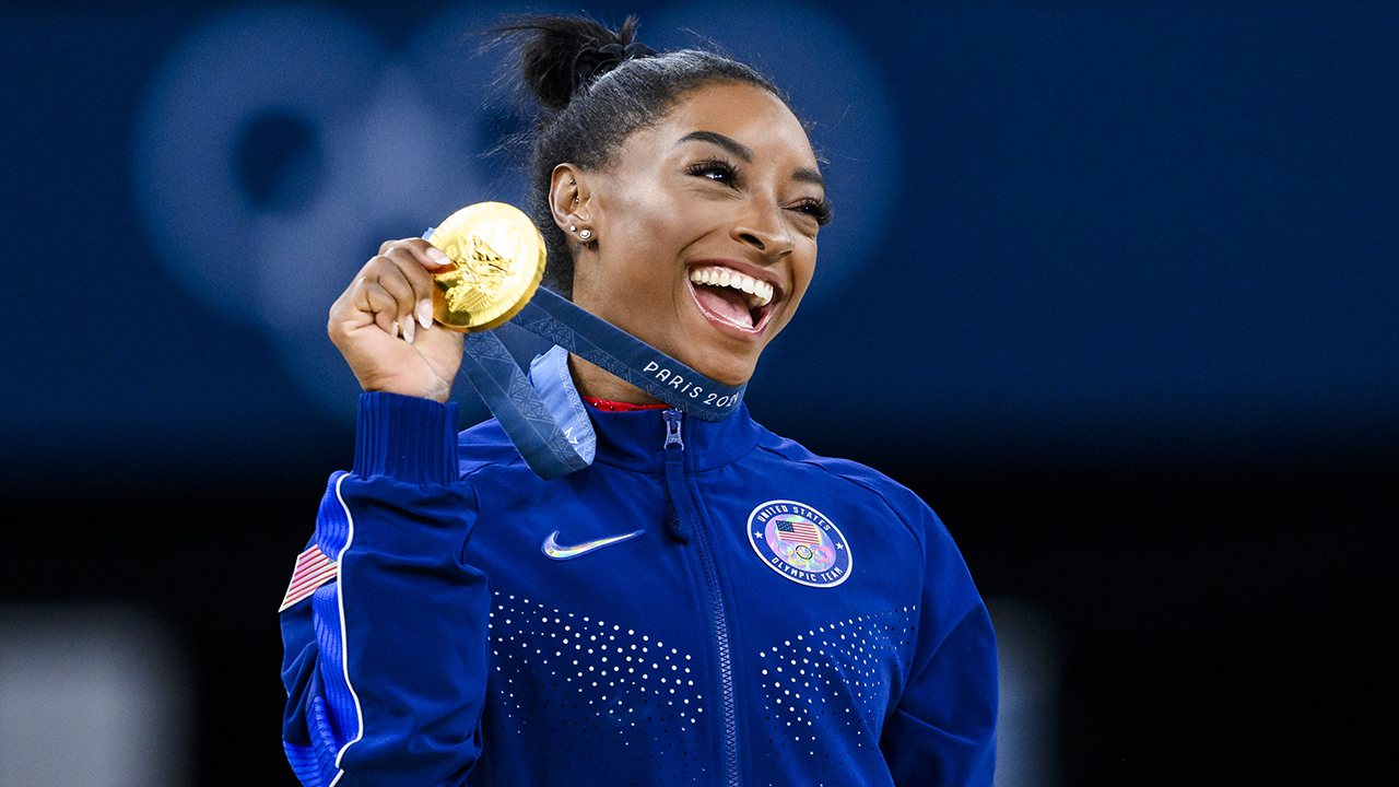 Gold mealist Simone Biles of Team United States celebrates on the podium during the medal ceremony for the Artistic Gymnastics Women's Vault Final on day eight of the Olympic Games Paris 2024 at the Bercy Arena on August 3, 2024 in Paris, France.