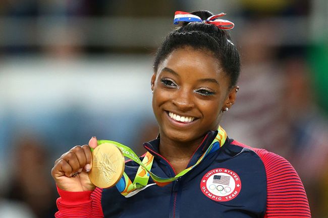 Gold medalist Simone Biles of the United States celebrates on the podium at the medal ceremony for the Women's Floor on Day 11 of the Rio 2016 Olympic Games at the Rio Olympic Arena on August 16, 2016 in Rio de Janeiro, Brazil.