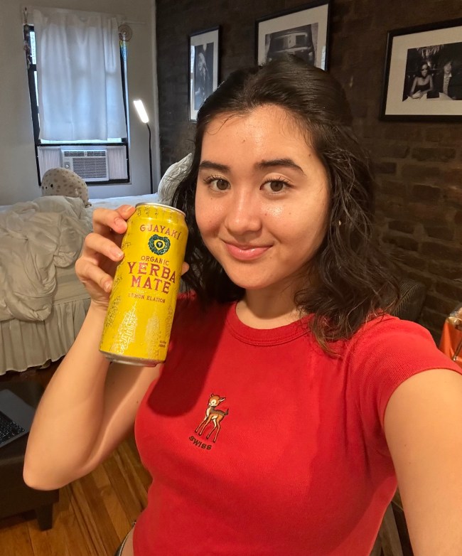 A woman holding a can of Yerba Mate