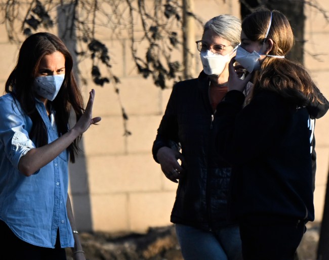 Meghan Markle, left, Duchess of Sussex member of the British royal family with two unidentified women at a home that was destroyed during the Eaton Fire in Altadena on Friday, January 10, 2025.