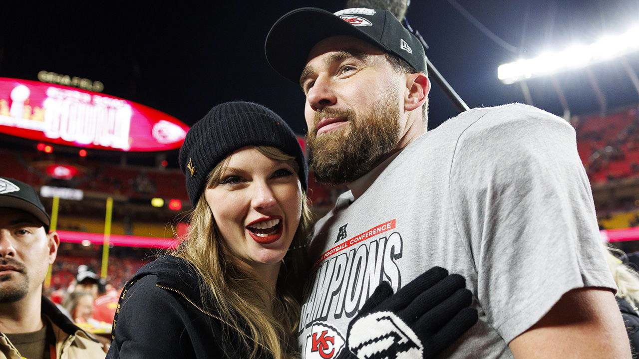 KANSAS CITY, MISSOURI - JANUARY 26: Tight end Travis Kelce #87 of the Kansas City Chiefs celebrates with Taylor Swift after the AFC Championship football game against the Buffalo Bills, at GEHA Field at Arrowhead Stadium on January 26, 2025 in Kansas City, Missouri.