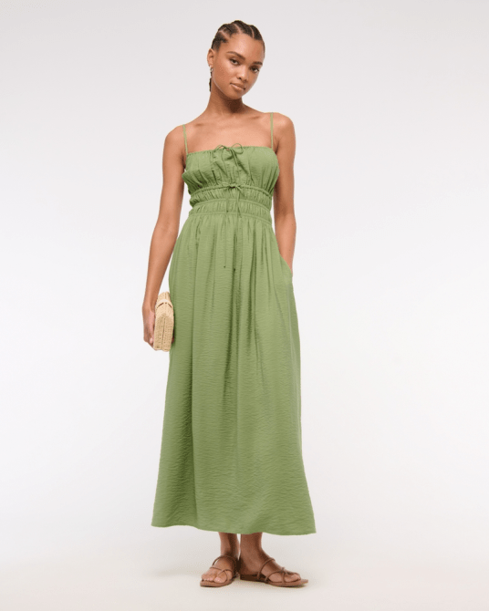 A model wearing the Abercrombie & Fitch Smocked Tie-Front Maxi Dress in light green
