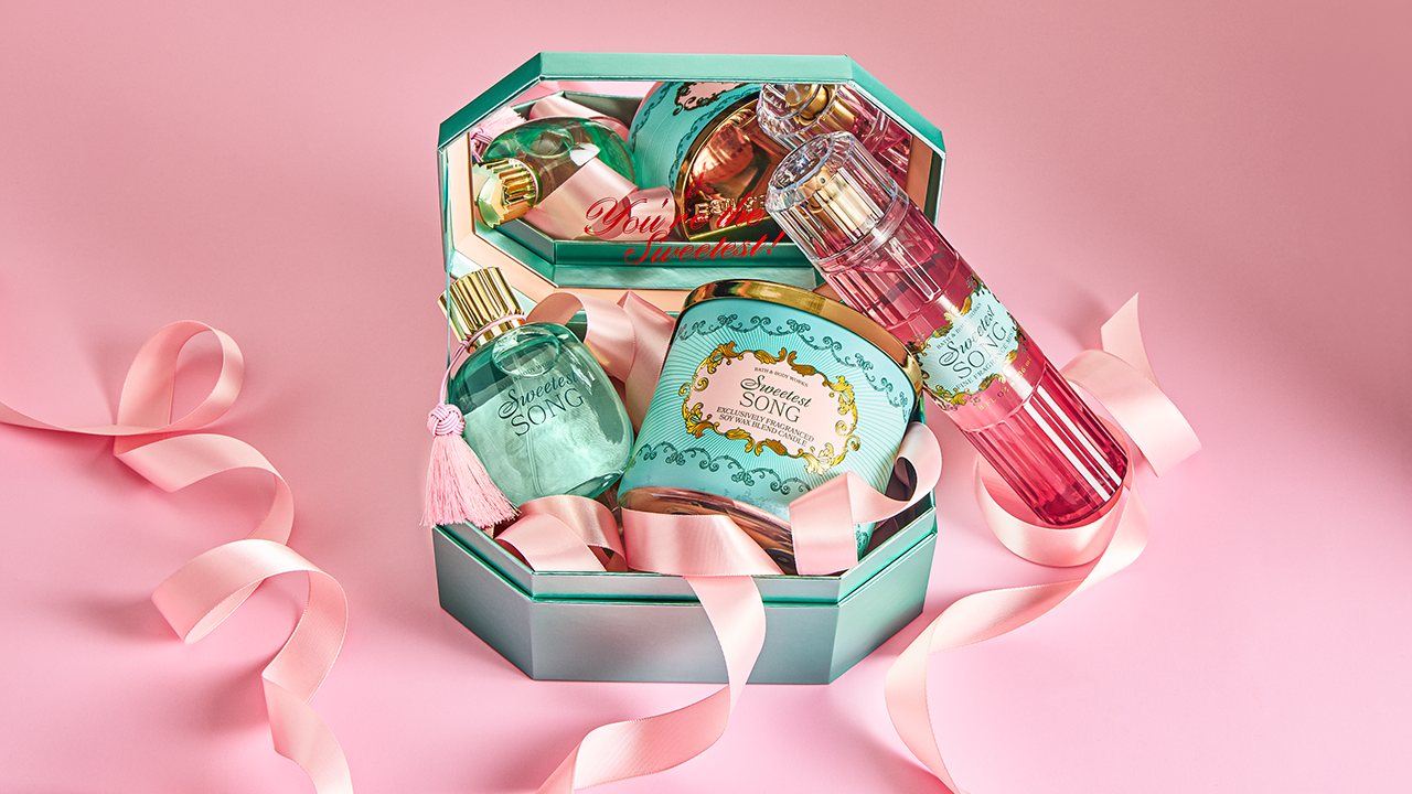 Three products from Bath & Body Works' Sweetest Song collection inside of a turquoise box with light pink ribbon throughout.