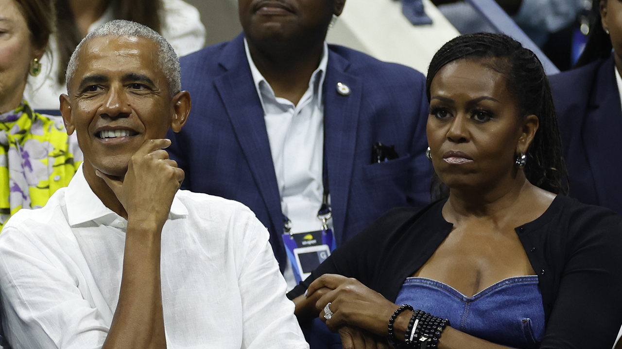 NEW YORK, NEW YORK - AUGUST 28: Former President of the United States Barack Obama, his wife Michelle Obama, and Chairman of the Board and President of the United States Tennis Association Brian Hainline (L) look on during the Men's Singles First Round match between Novak Djokovic of Serbia and Alexandre Muller of France on Day One of the 2023 US Open at the USTA Billie Jean King National Tennis Center on August 28, 2023 in the Flushing neighborhood of the Queens borough of New York City.