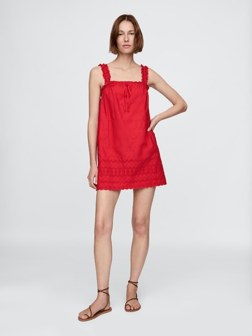 A model wearing the Gap x Dôen Eyelet Shift Mini Dress in bright red