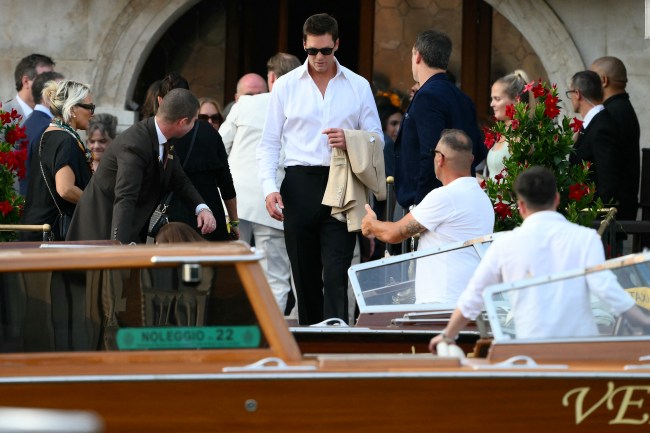 US football player Tom Brady gets on a taxi boat at the Gritti Palace Hotel ahead of the wedding of Amazon's founder Jeff Bezos with Lauren Sanchez in Venice on June 26, 2025. Celebrities in superyachts sail into Venice this week for the three-day wedding party of Amazon tycoon Jeff Bezos and Lauren Sanchez, despite irate locals who say the UNESCO city is no billionaire's playground. The tech magnate and journalist have reportedly invited about 200 guests to their multi-million dollar nuptials in the Italian city, which are expected to kick off on June 26 and end Saturday with a ceremony at a secret location.