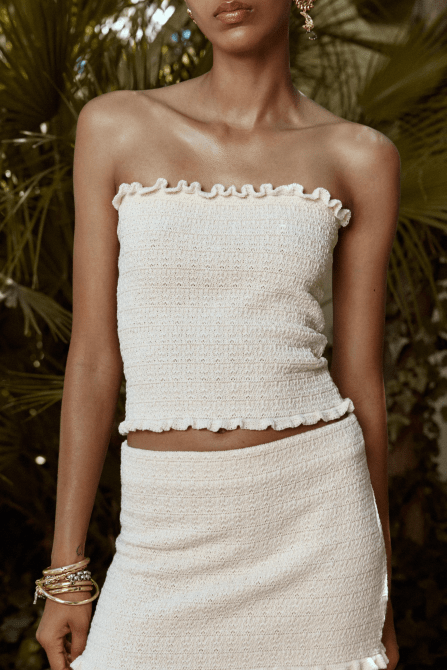 A model wearing the Zara Knit Bandeau Top in white
