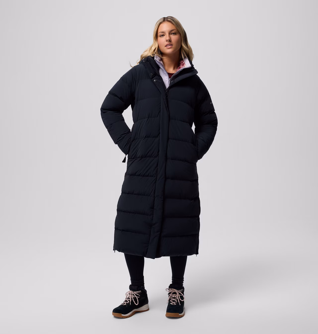 A model wearing the Columbia Amaze Puff™ Long Hooded Jacket in black
