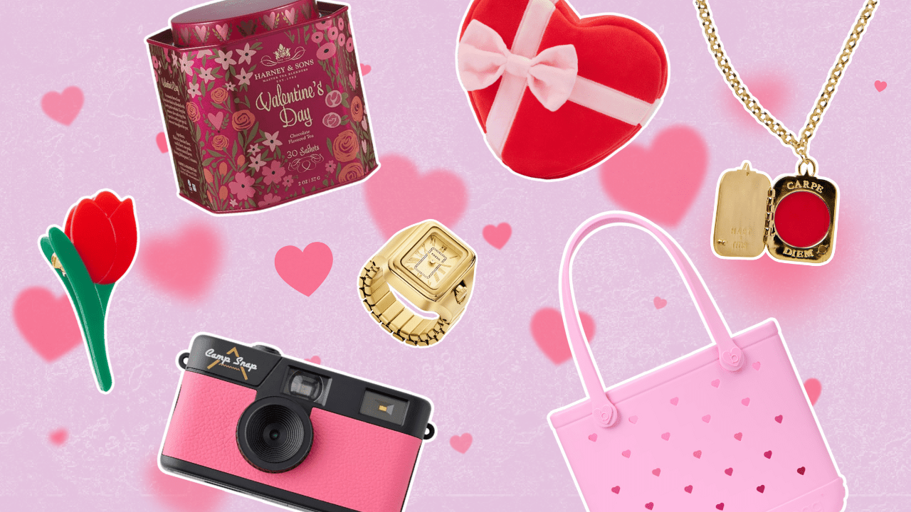 Pink background with red hearts featuring a tulip hair clip, retro pink camera, pink Bogg Bag, Valentine's Day tea, a red heart dog toy, and gold jewelry